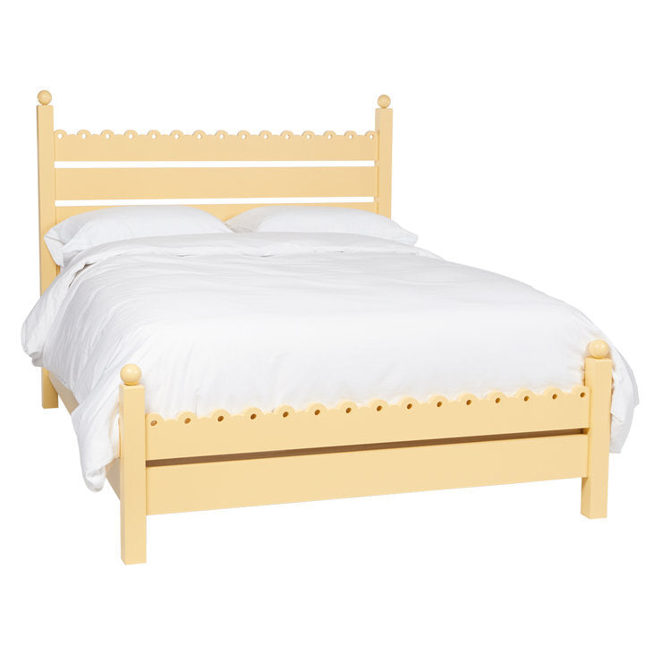 Ginger Cutout Bed in sunny yellow with scalloped detailing and round finials on headboard and footboard